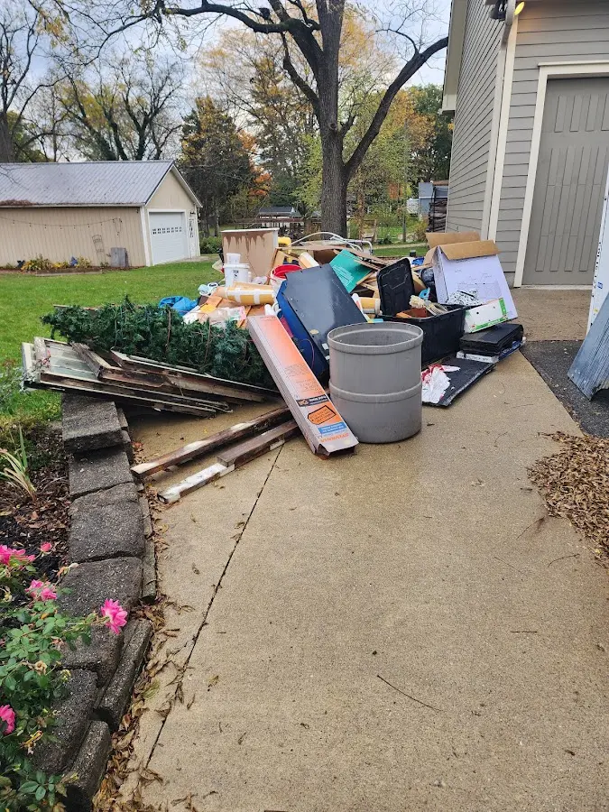 Dumpster being loaded with debris for Estate Cleanout Dumpster Rental in Mayflower Village